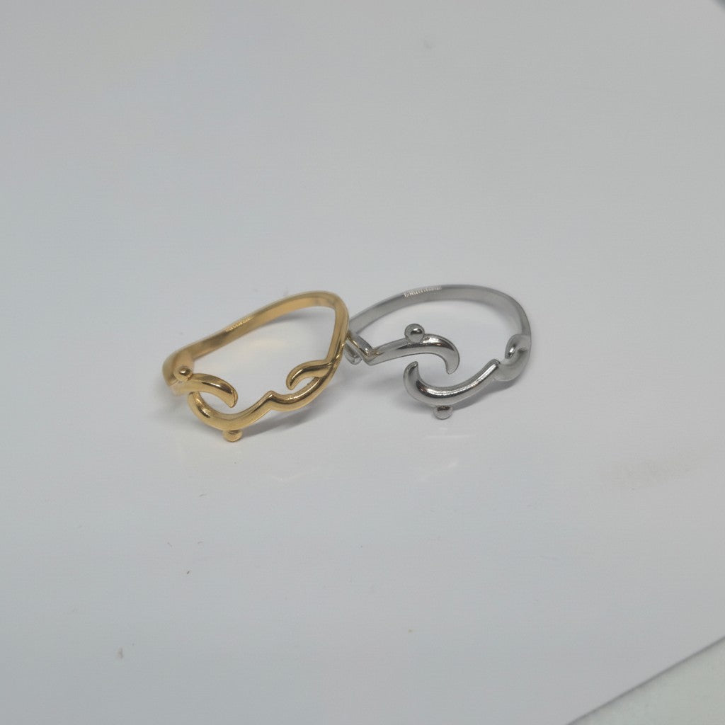 Majoa gold and silver calligraphy rings spelling "amour" in Arabic script. Modern, open design.