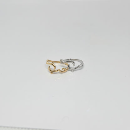 Majoa gold and silver calligraphy ring spelling 'amour' with a fluid, elegant design. Modern, symbolic jewelry.