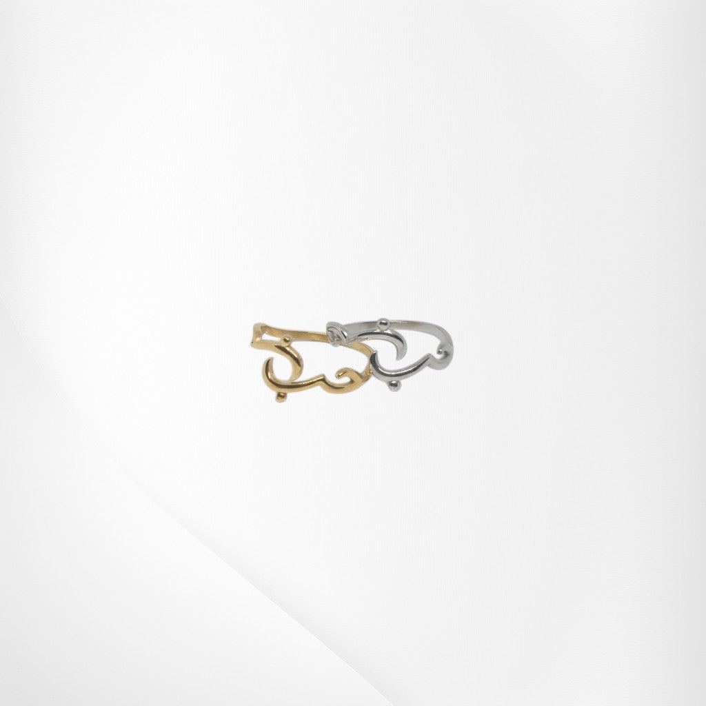 Majoa gold and silver calligraphy ring spelling 'amour' with a fluid, elegant design. Modern, symbolic jewelry.