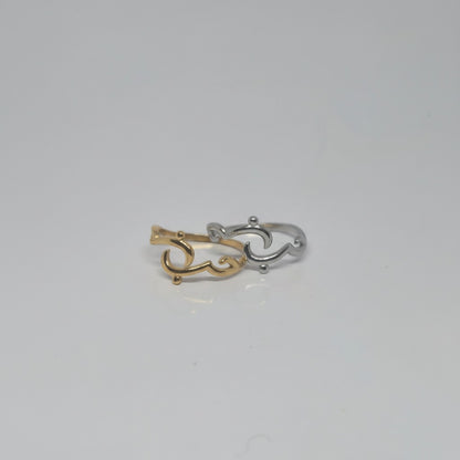 Majoa gold and silver calligraphy rings spelling 'amour' with an open design. Modern, symbolic jewelry.