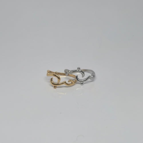 Majoa gold and silver calligraphy rings spelling 'amour' with an open design. Modern, symbolic jewelry.