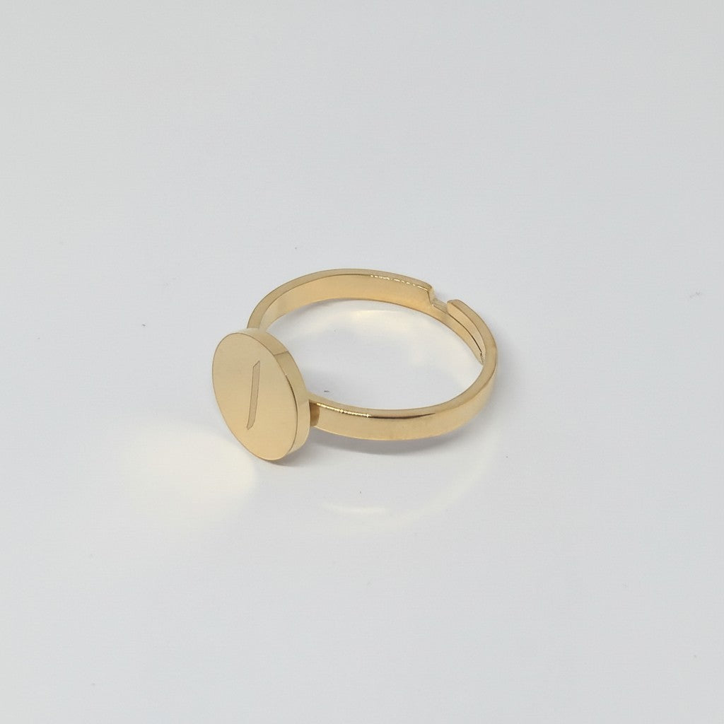 Majoa gold stainless steel ring with a round medallion engraved with the Arabic letter Nun.